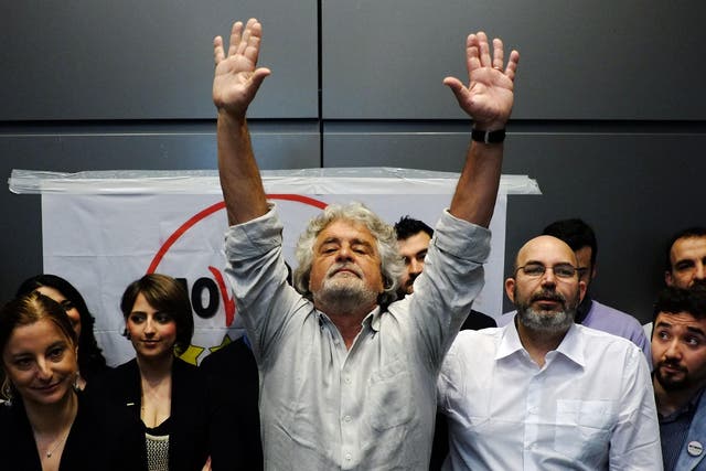 Five-Star Movement leader Beppe Grillo gestures during a news conference in Rome, 2013
