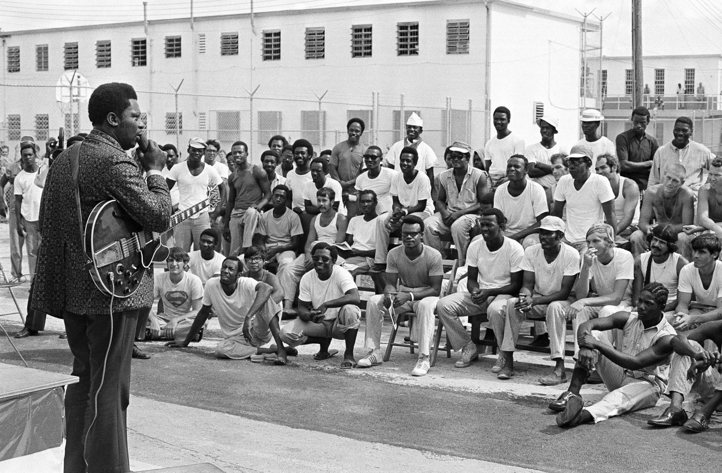 A group of prisoners at the Dade County stockade listen to B.B. King
