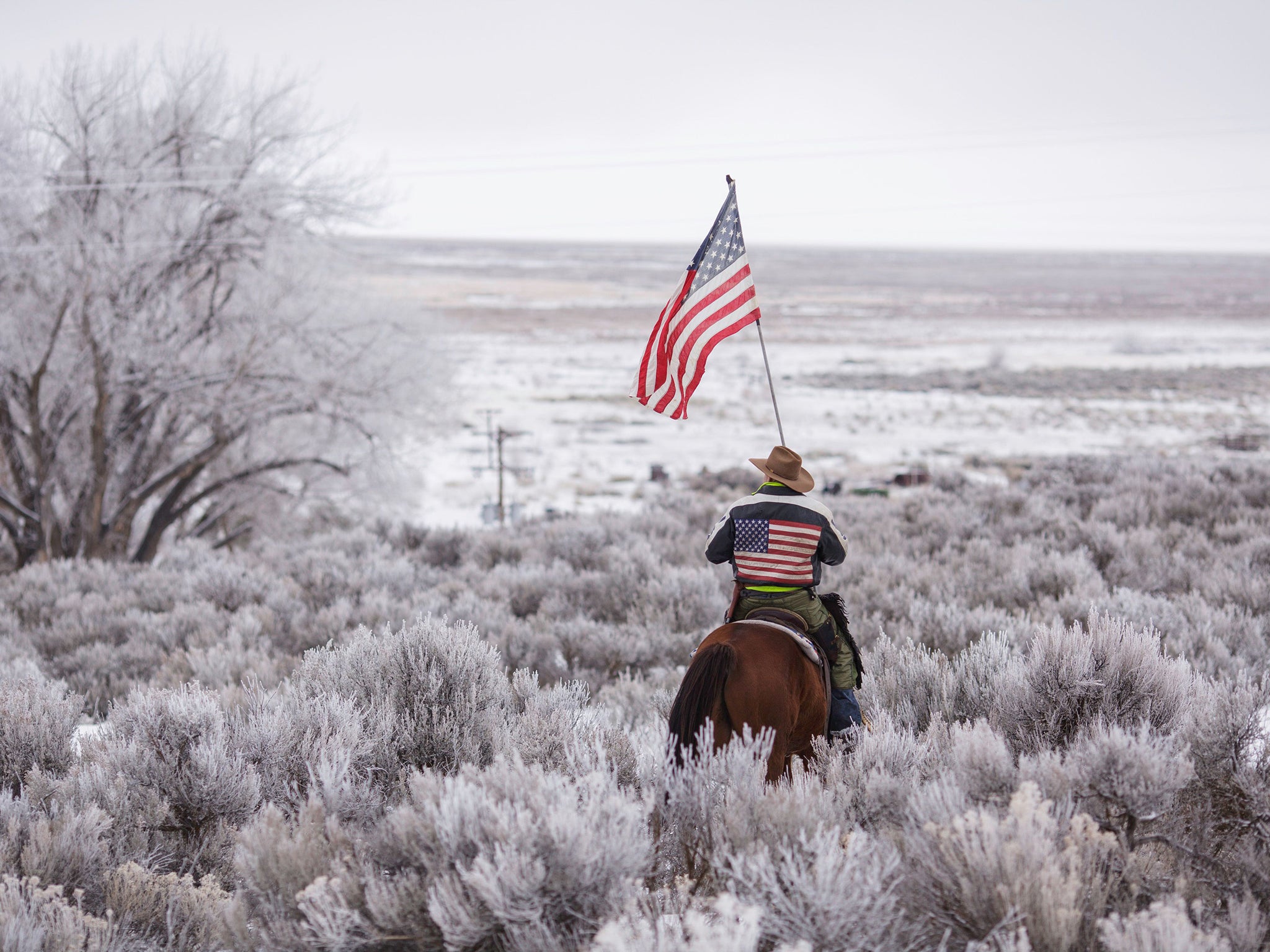 An activist rides through scrub near the Malheur National Wildlife Refuge headquarters during the 41-day occupation