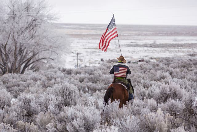 An activist rides through scrub near the Malheur National Wildlife Refuge headquarters during the 41-day occupation