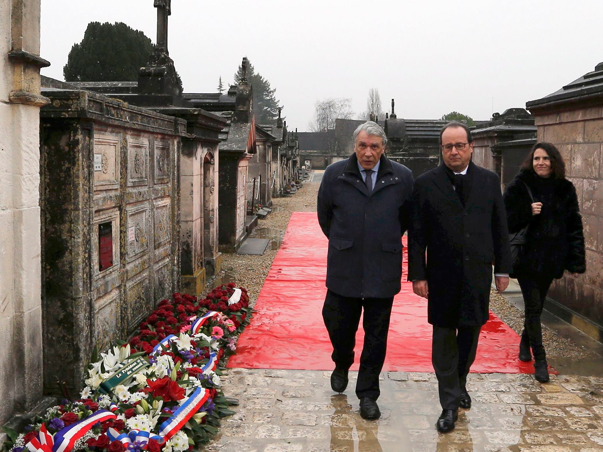French President Francois Hollande (C), Gilbert Mitterrand (L) and Mazarine Pingeot arrive at the cemetery to attend a ceremony marking the 20th anniversary of the death of former French President Francois Mitterrand in Jarnac, France