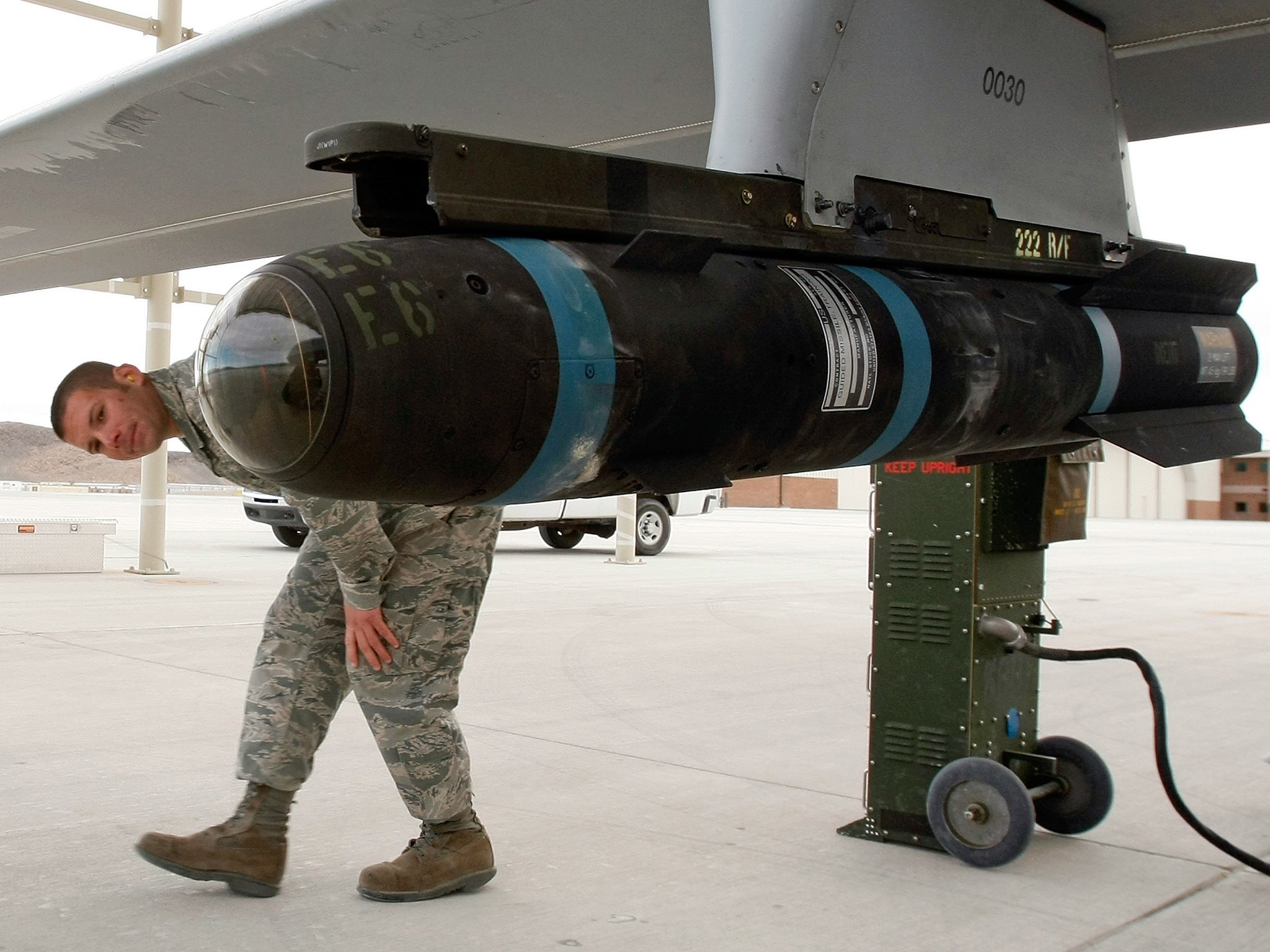 A Hellfire missile sits underneath a MQ-1B Predator unmanned aircraft system
