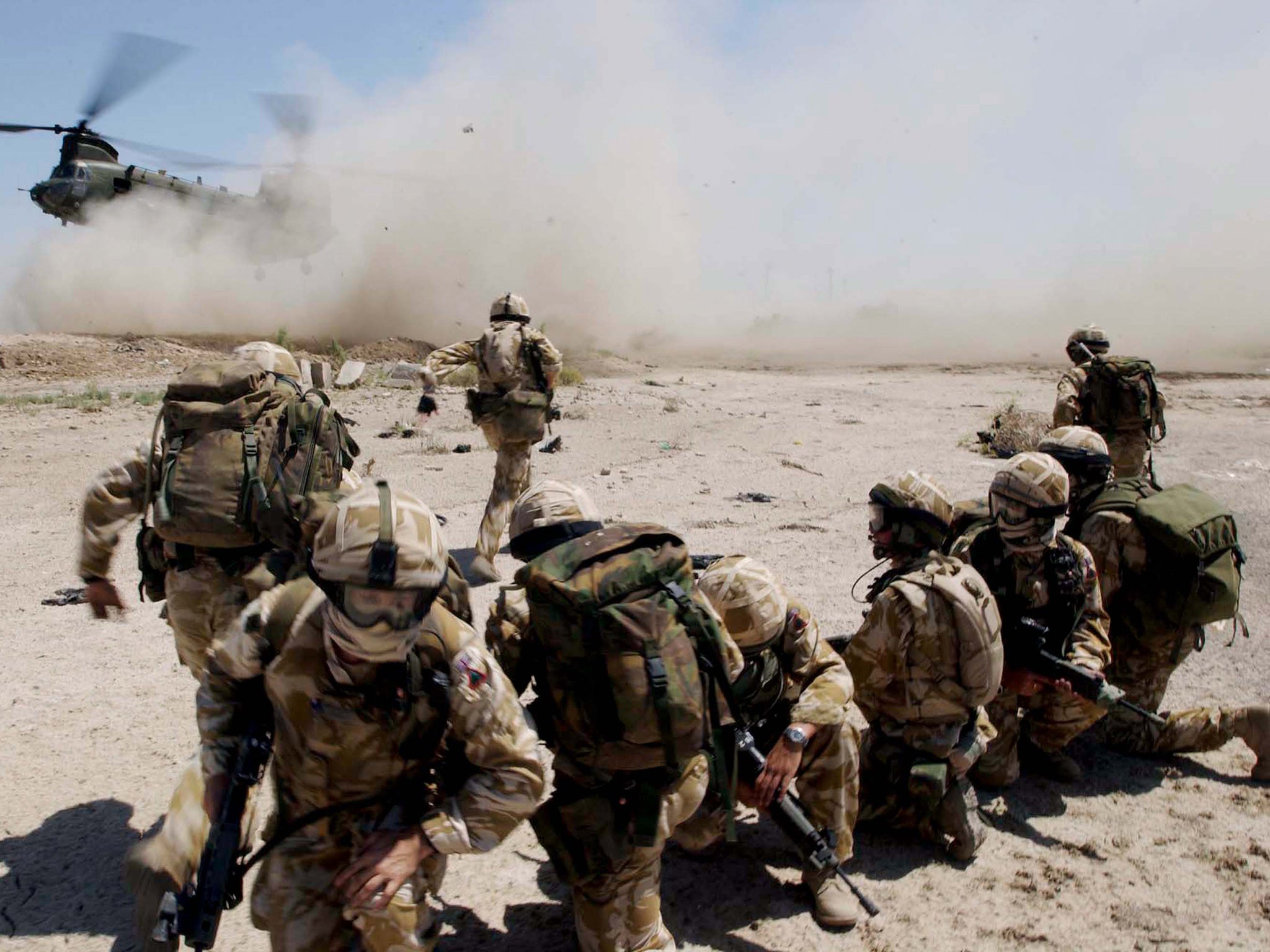 Soldiers mount a helicopter July 2, 2004 around the southern Iraqi town of Basra