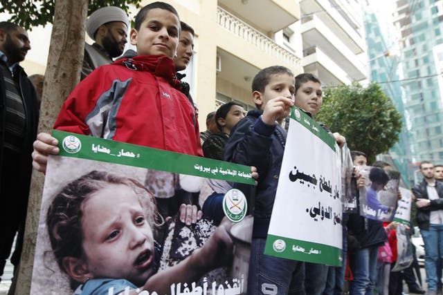Protesters with placards showing children from Madaya in front of the International Committee of the Red Cross headquarters in Beirut yesterday