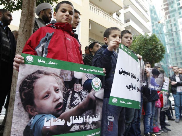 Protesters with placards showing children from Madaya in front of the International Committee of the Red Cross headquarters in Beirut yesterday