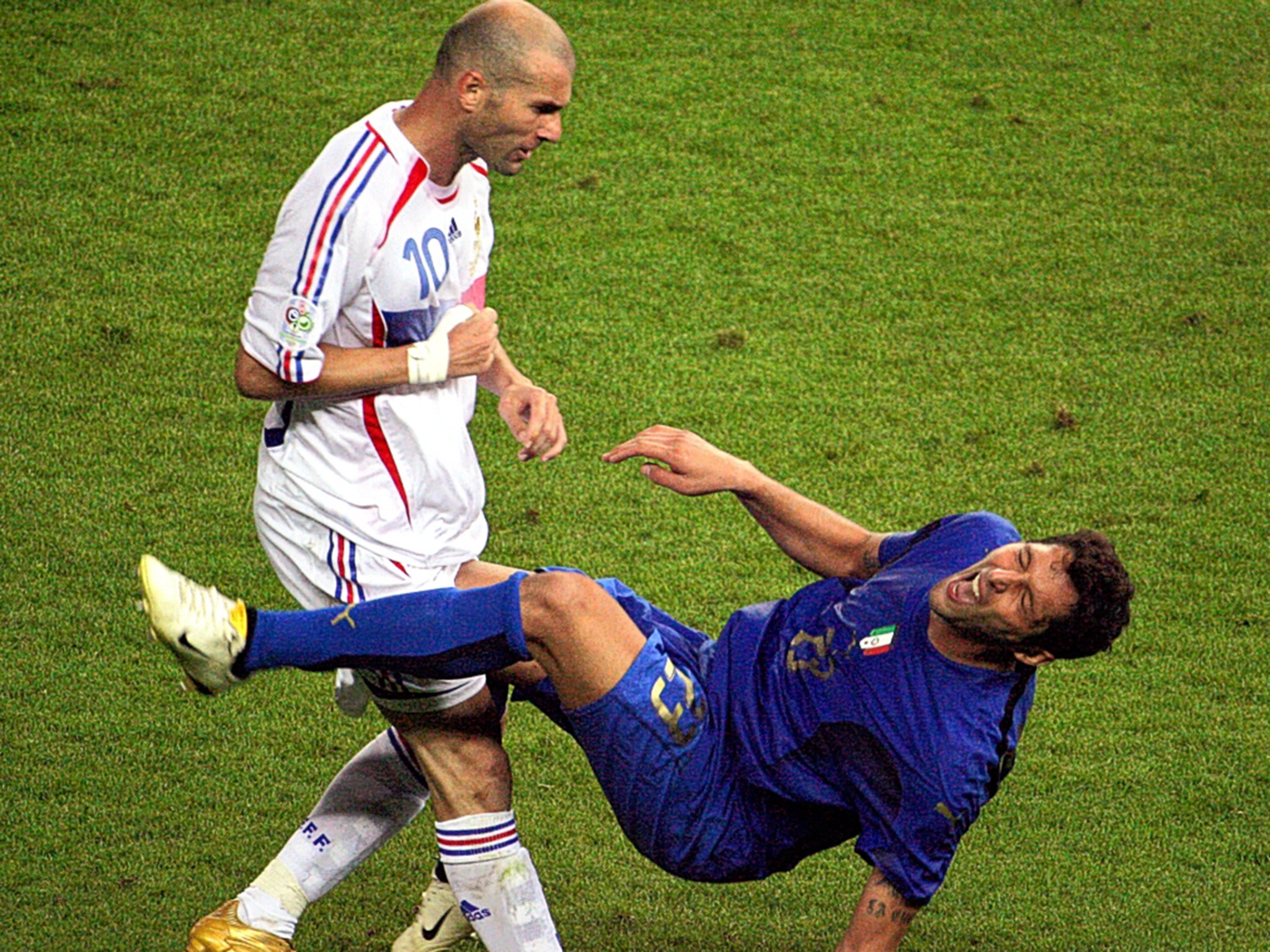 Zinedine Zidane (left), who is ‘not a nice guy’ according to former France coach Raymond Domenech, fells Italy’s Marco Materazzi with a headbutt in the 2006 World Cup final