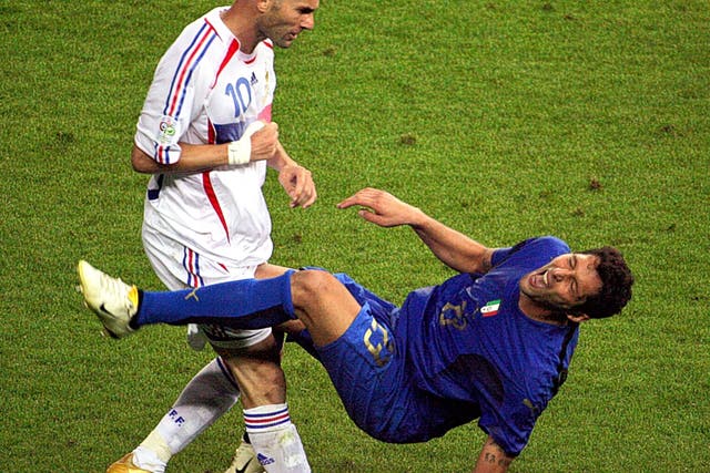 Zinedine Zidane (left), who is ‘not a nice guy’ according to former France coach Raymond Domenech,  fells Italy’s Marco Materazzi with a headbutt in the 2006 World Cup final