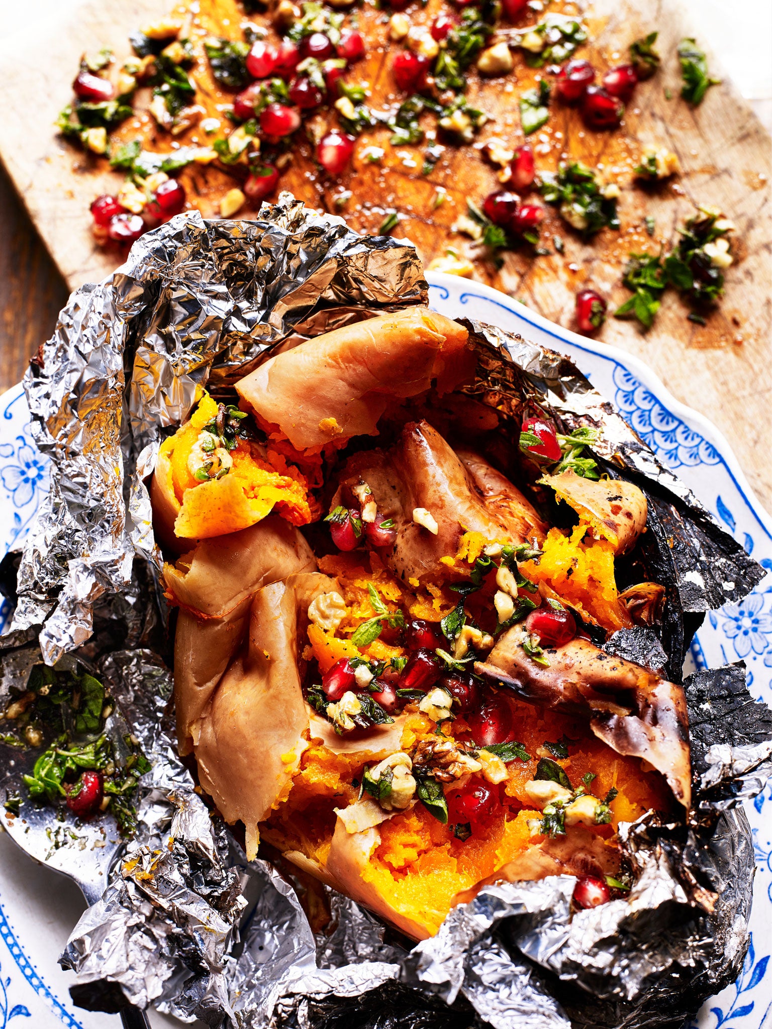 Winter squash cooked in embers with walnut, pomegranate and marjoram gremolata (Kris Kirkham)