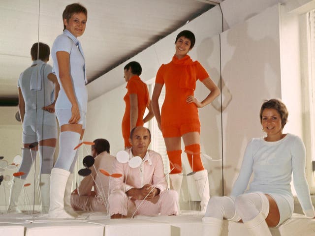 André Courrèges (centre) sits among his models in 1976