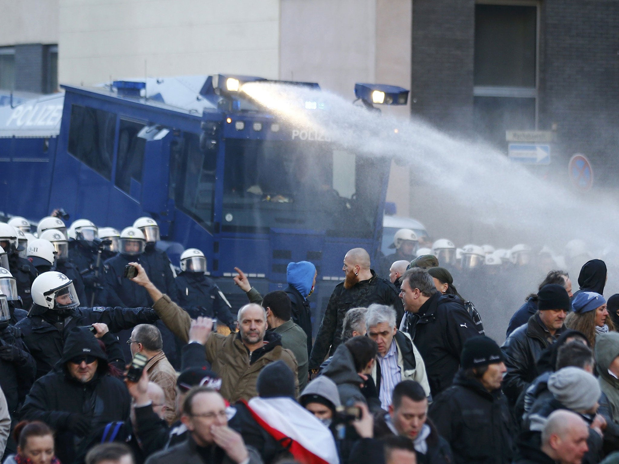 Police use a water cannon during a protest march by supporters of anti-immigration right-wing movement Pegida in Cologne, Germany, January 9, 2016