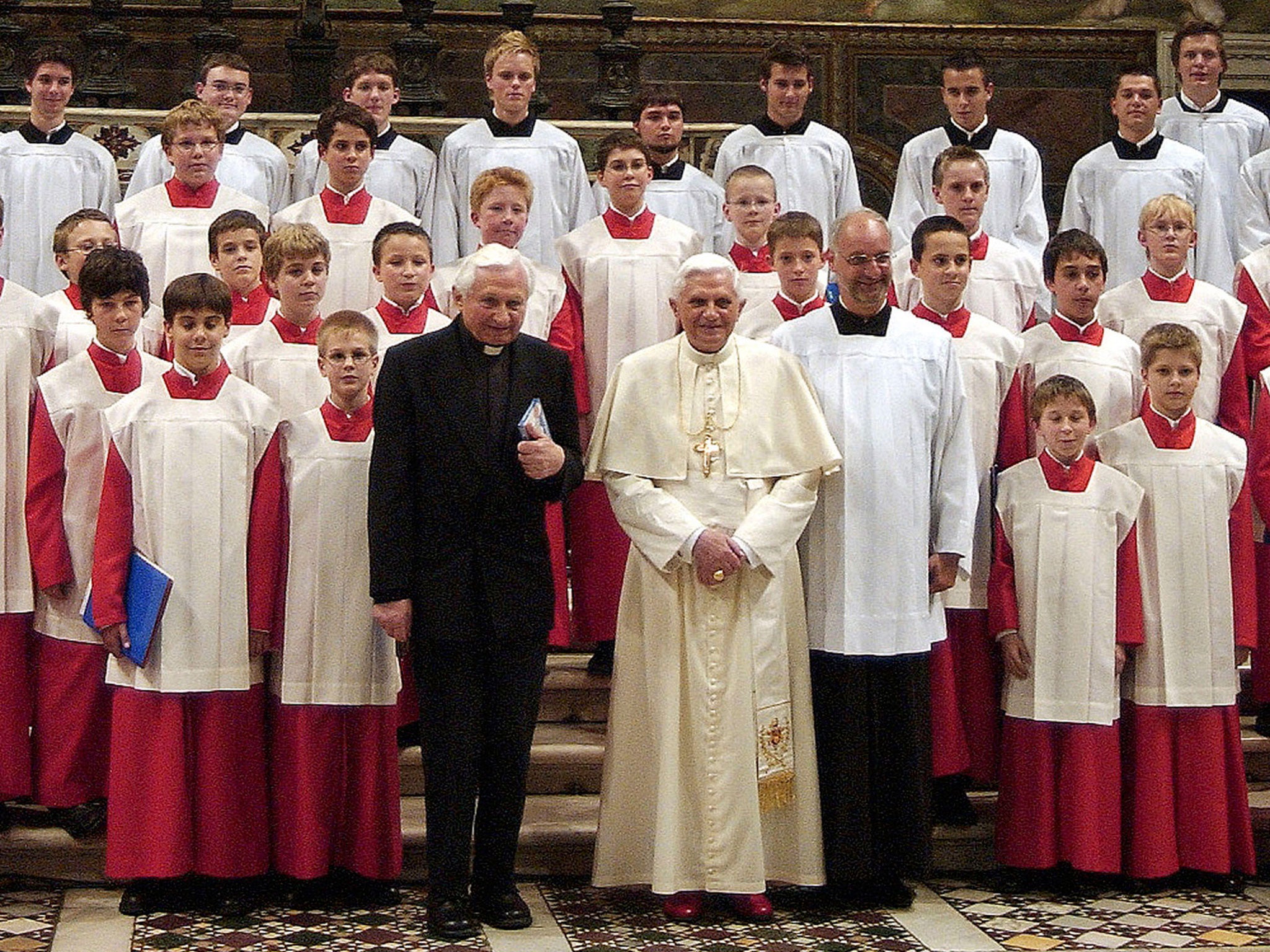 Pope Benedict XVI with his brother Georg Ratzinger and Archbishop Piero Marini (R), after a concert by the Regensburger Domspatzen boys' choir at the Sistine Chapel in 2005