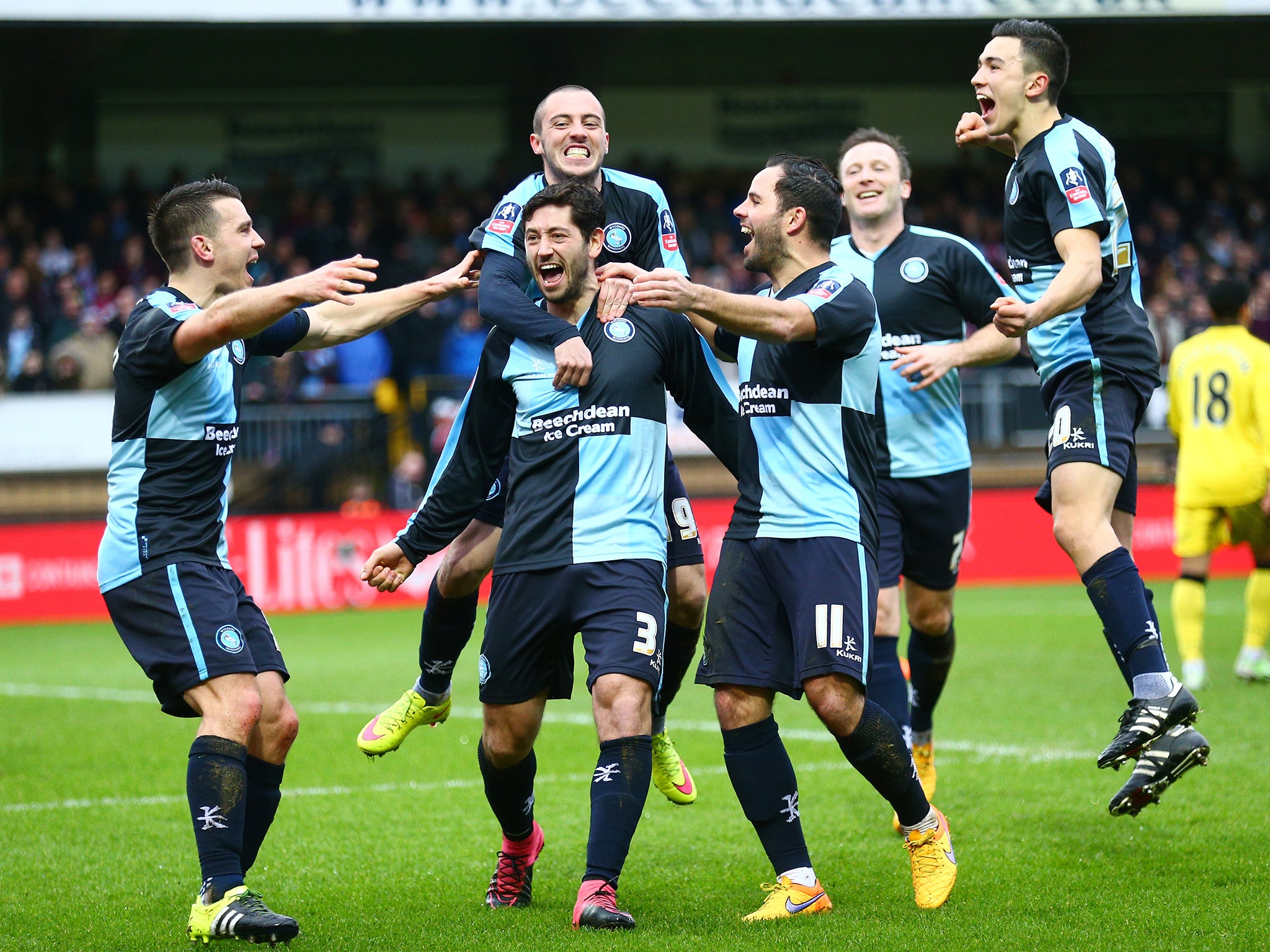 Joe Jacobson's Wycombe Wanderers team-mates congratulate him on his equaliser