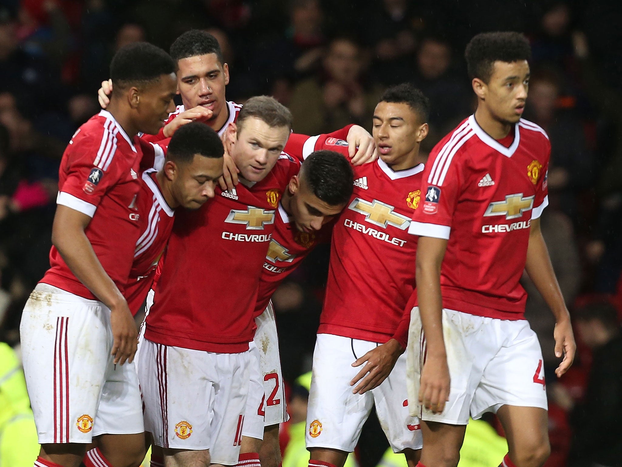 Wayne Rooney is congratulated by his Manchester United team-mates