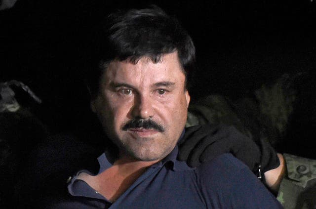 Drug kingpin Joaquin 'El Chapo' Guzman is escorted into a helicopter following his recapture