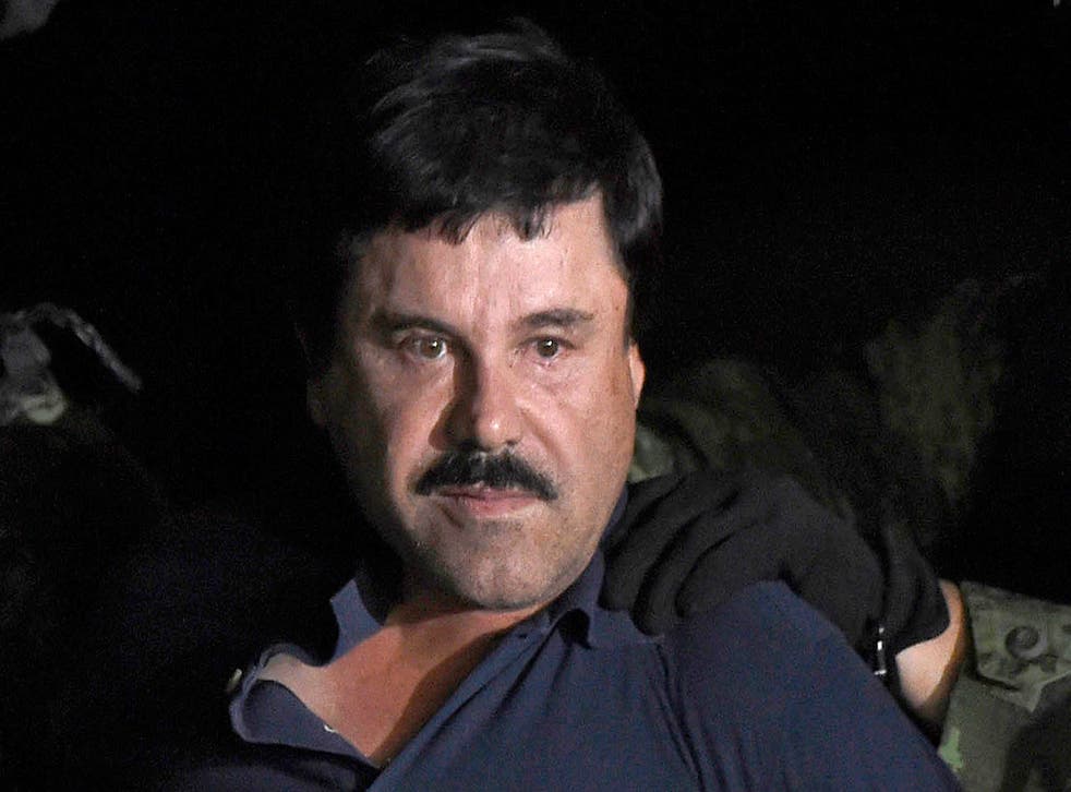 Drug kingpin Joaquin 'El Chapo' Guzman is escorted into a helicopter following his recapture