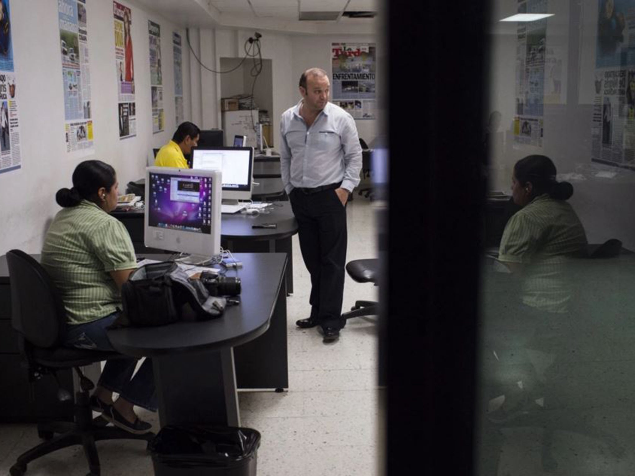 Hildebrando “Brando” Deandar Ayala, editor in chief of El Mañana, center, checks in with different departments at the newspaper’s office in Reynosa, Mexico