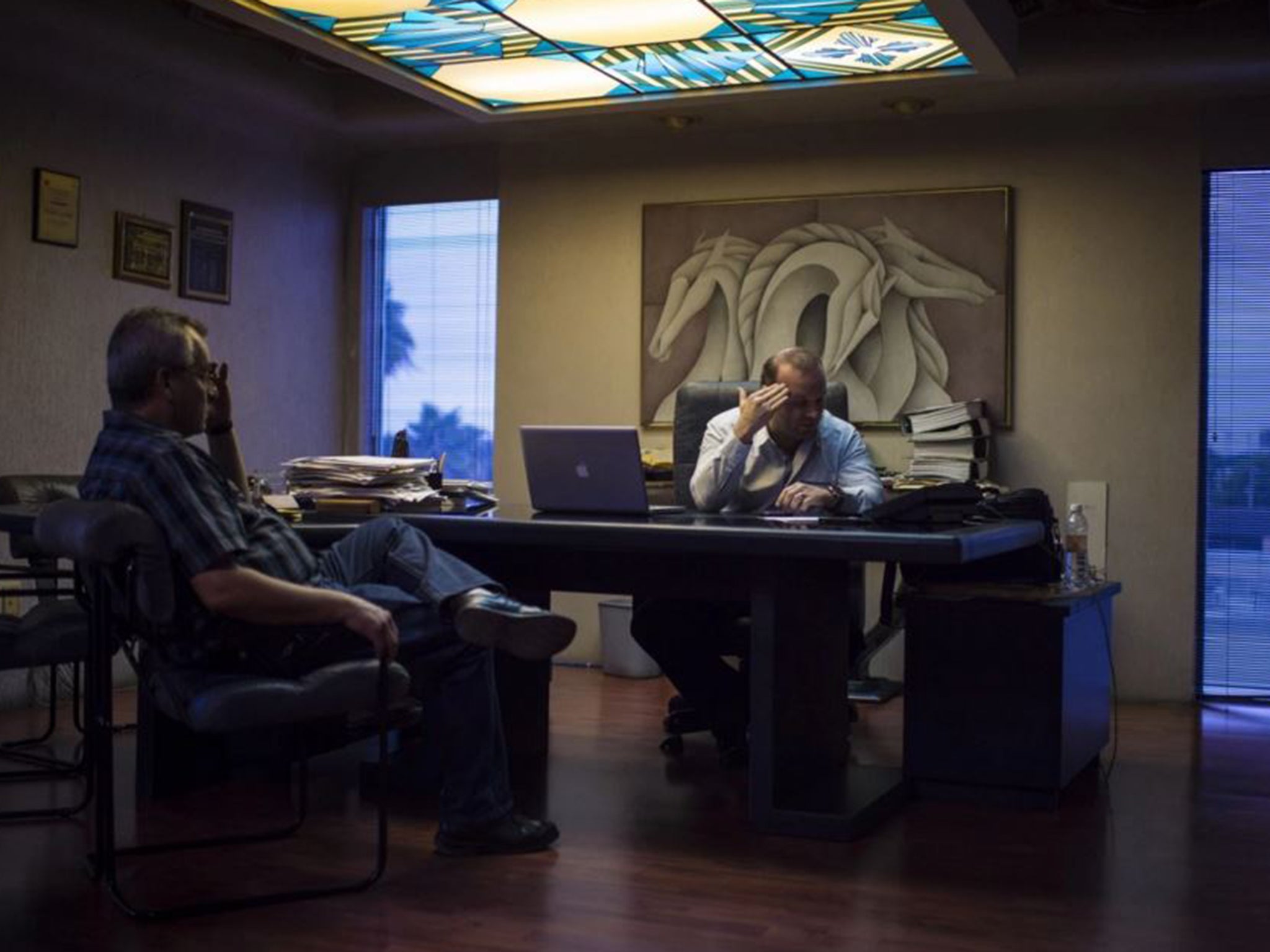 Hildebrando Deandar Ayala, editor in chief of El Mañana, right, and Enrique Juarez, his Matamoros editor who was kidnapped by the cartel in February because the paper defied its news blackout, discuss coverage in Deandar’s office