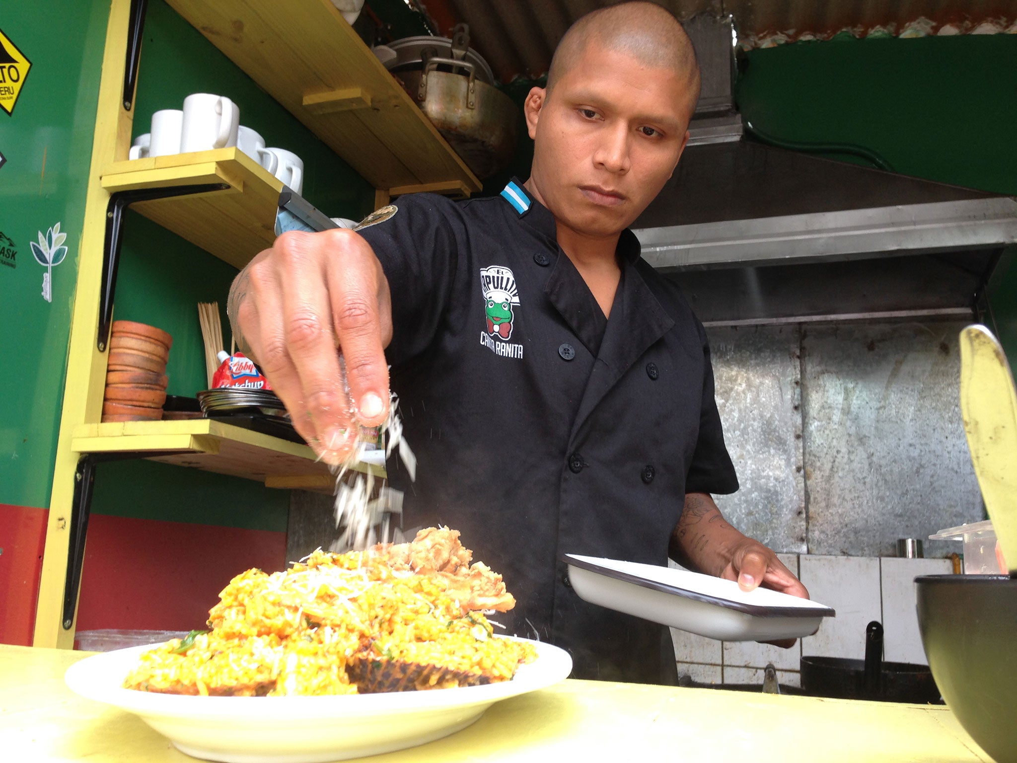 Putting the finishing touches to rice with seafood at the Canta Ranita