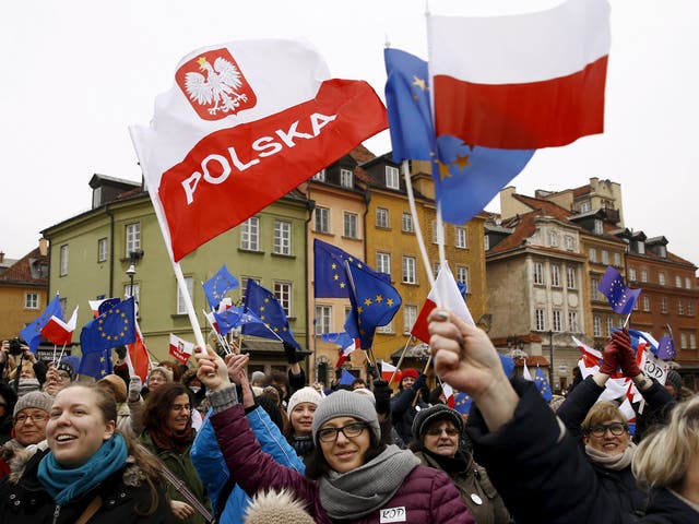 Waving EU flags, Poles demonstrate against the new measures in Warsaw’s Old Town