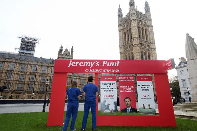 Campaigners for the junior doctors’ cause set up a fake betting shop frontage outside Parliament