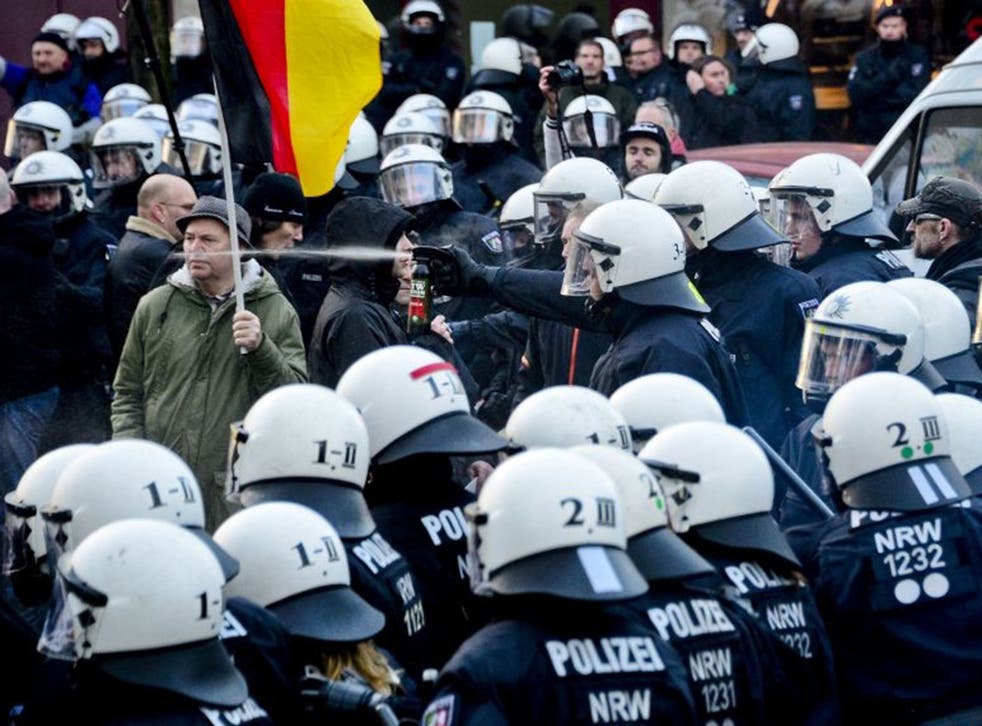 Police use pepper spray to control supporters of Pegida, Hogesa (Hooligans against Salafists) and other right-wing populist groups as they protest against the New Year's Eve sex attacks on 9 January, 2016 in Cologne, Germany.