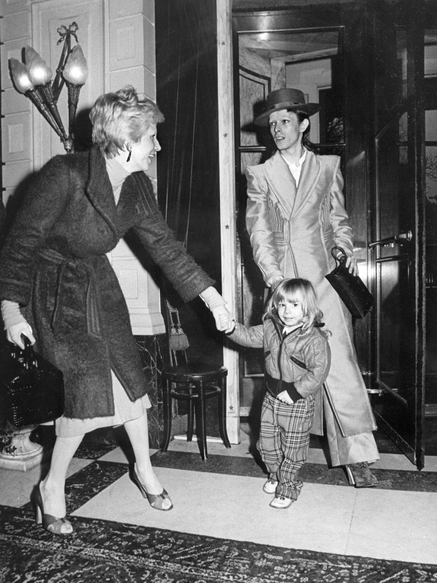 David Bowie, with his wife Angela (Angie) and his son Zowie, after receiving an award for his latest record "Ziggy stardust" in Amsterdam, 1974