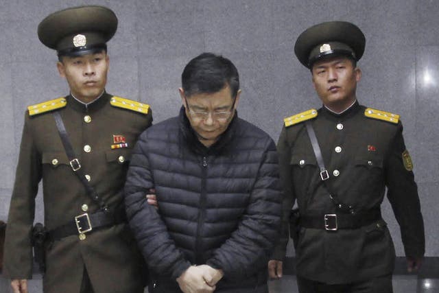 Hyeon Soo Lim, center being escorted to his sentencing in Pyongyang, North Korea in December