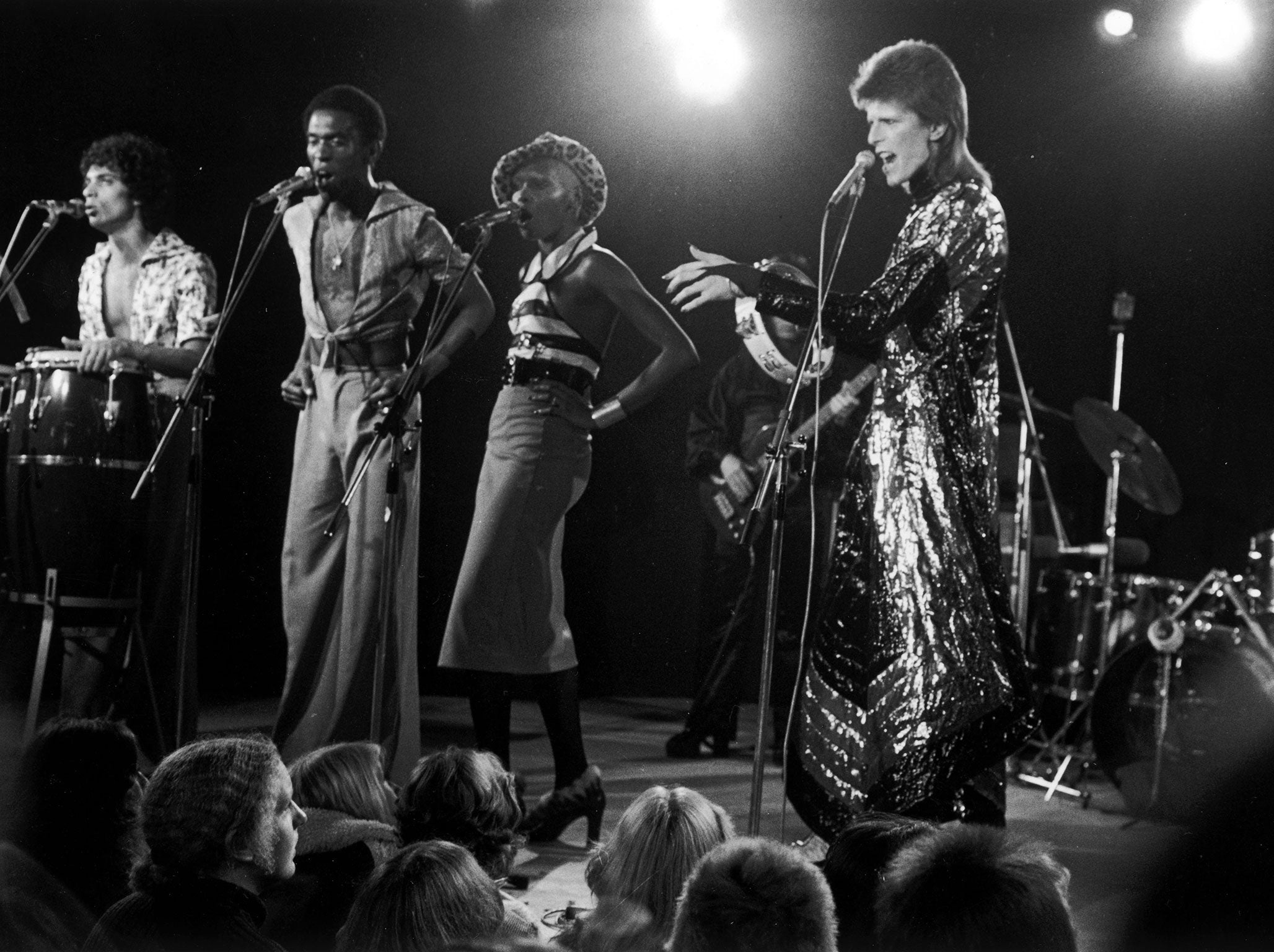 English singer David Bowie (right) performing at a live recording for a Midnight Special TV show made at The Marquee Club in London with a specially invited audience of Bowie fanclub members, 21st October 1973. Bowie is wearing a 'space-samurai' costume by Kansai Yamamoto