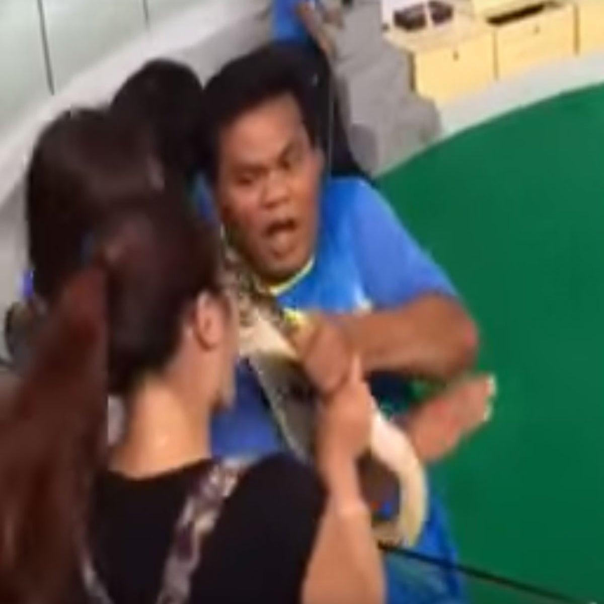 A tourist takes a bite from the chest of a Thai woman as they