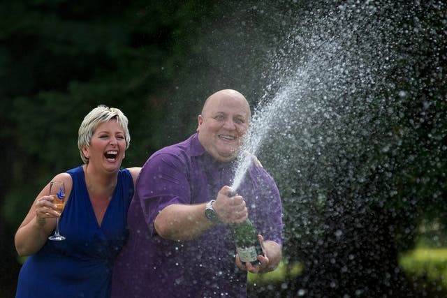 Adrian and Gillian Bayford spray champagne after winning more than £148 million on the EuroMillions