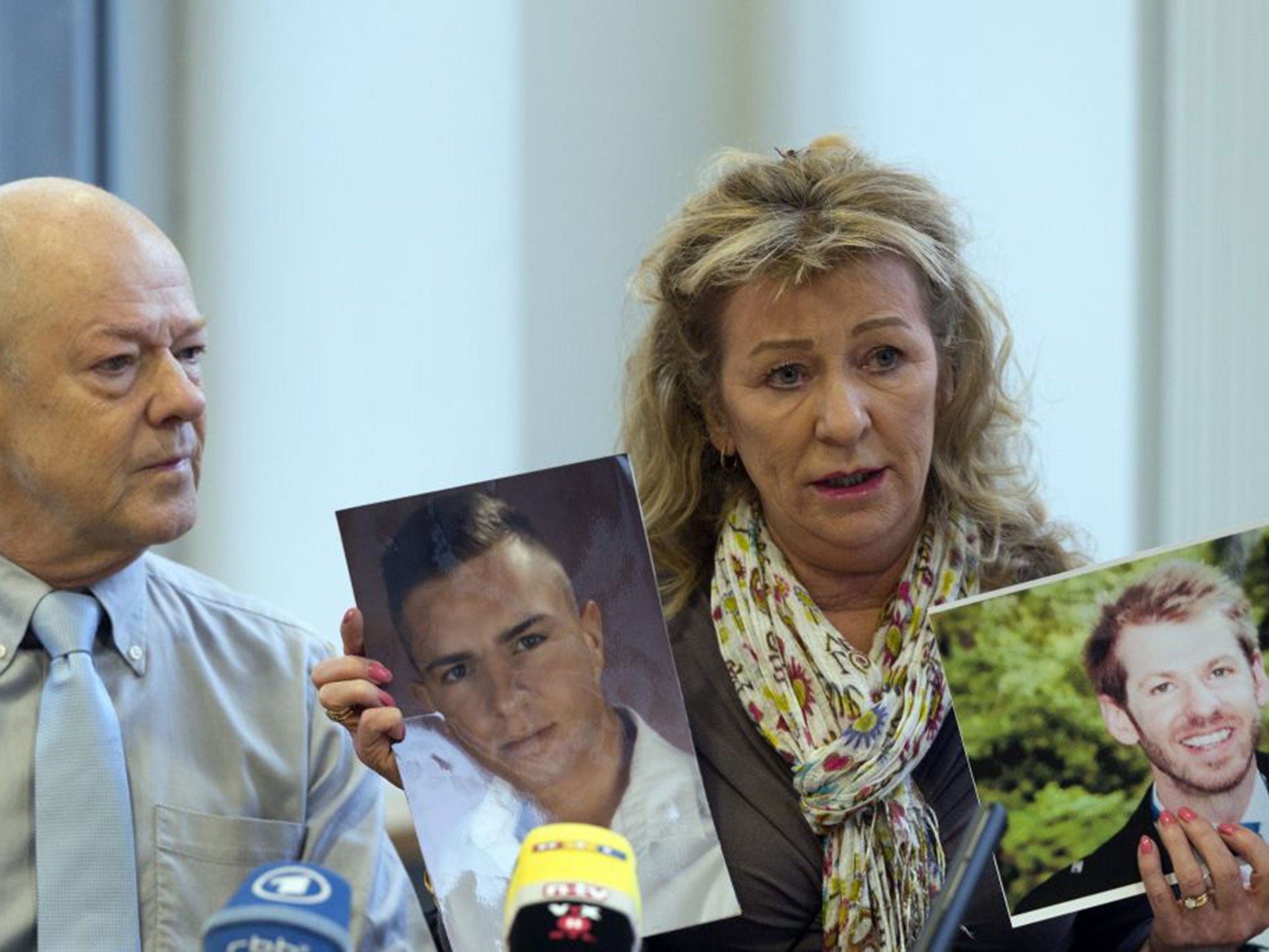 Phil and Rita Holland with photographs of their murdered son, Luke, right, and Burak Bektas, whom they believe was killed by the same man