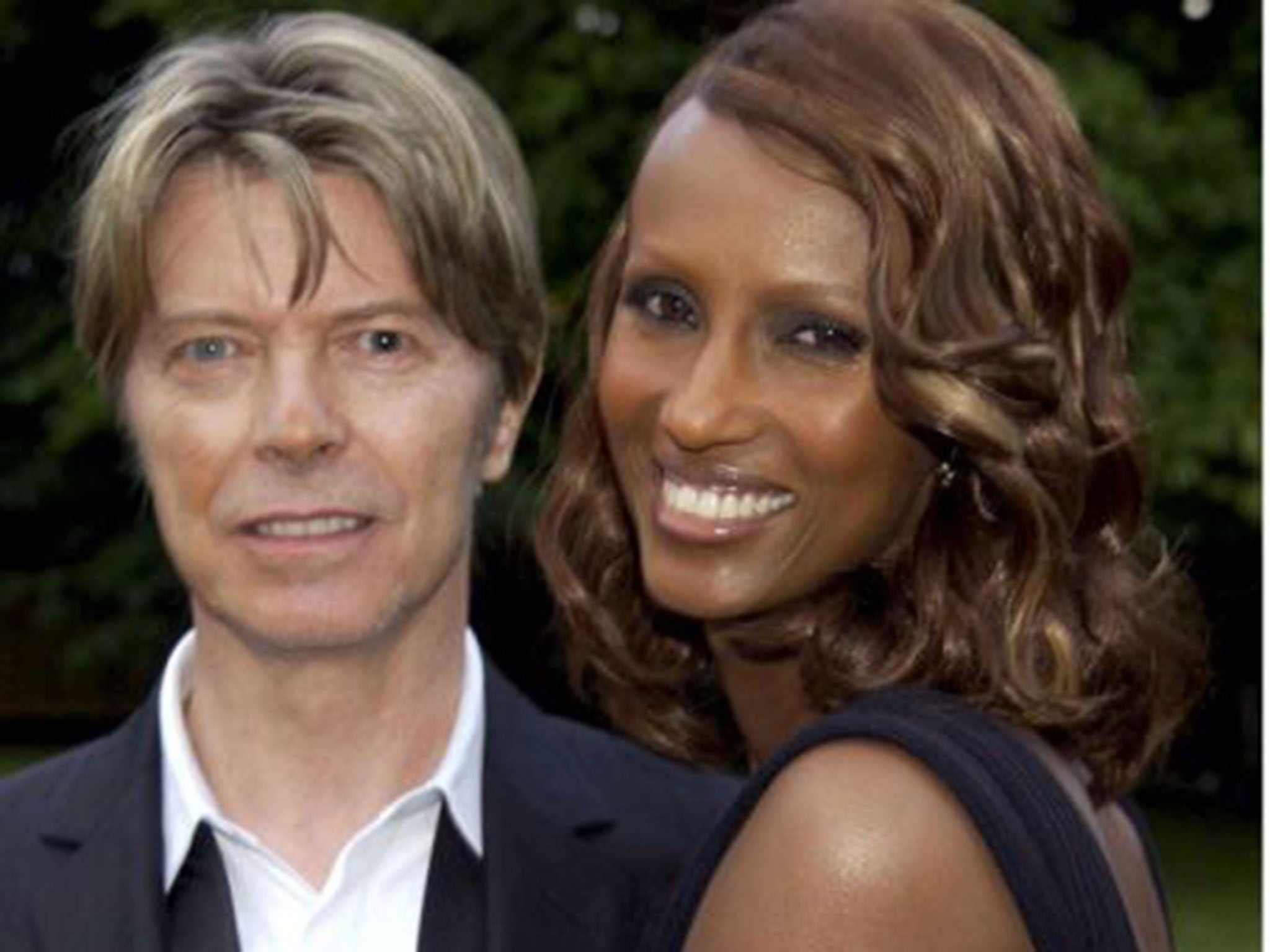 Bowie with Iman in 2002 (Rex)