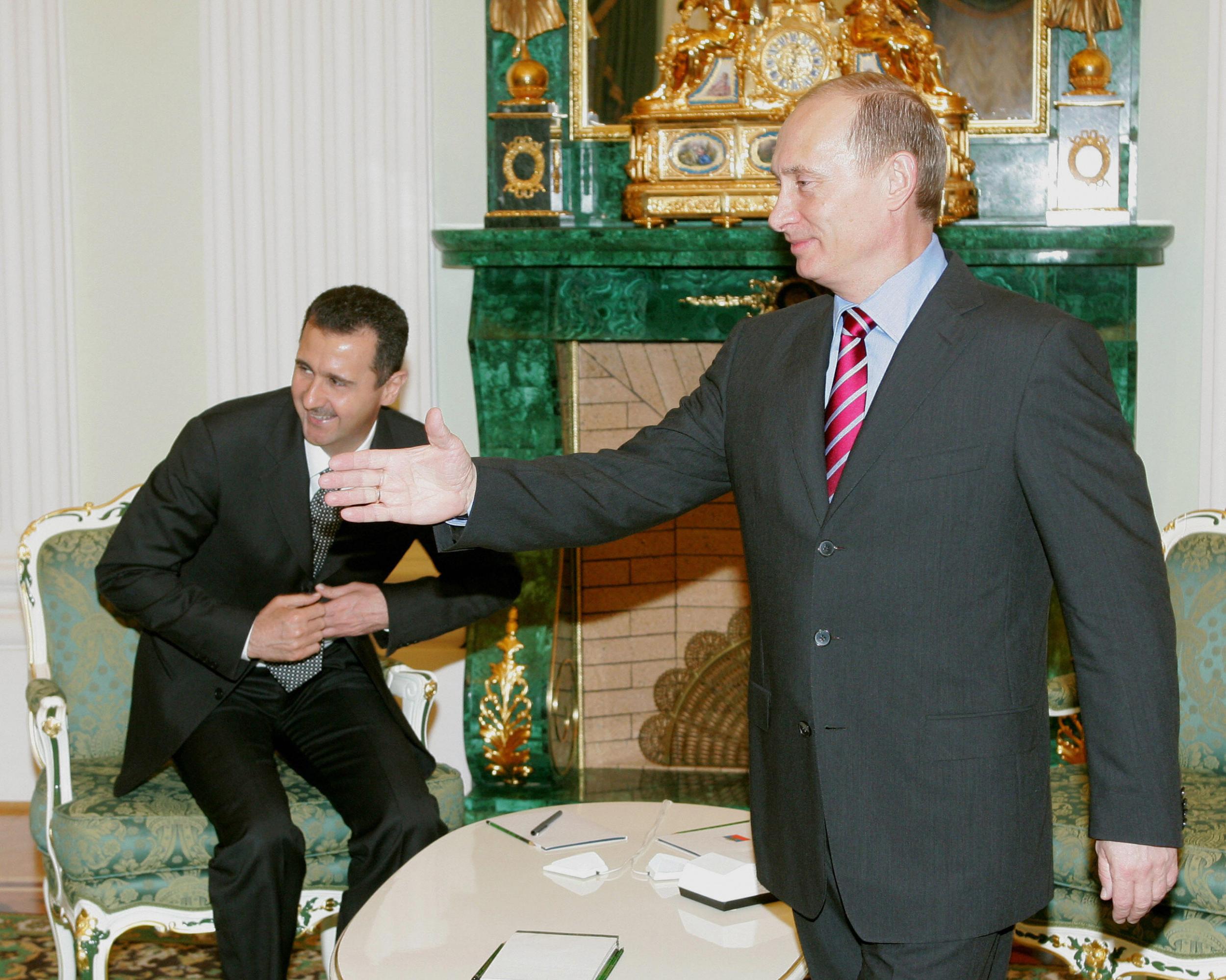 Vladimir Putin (right) said that although he considers the idea premature, he would be happy to offer Bashar al-Assad (left) asylum in Russia