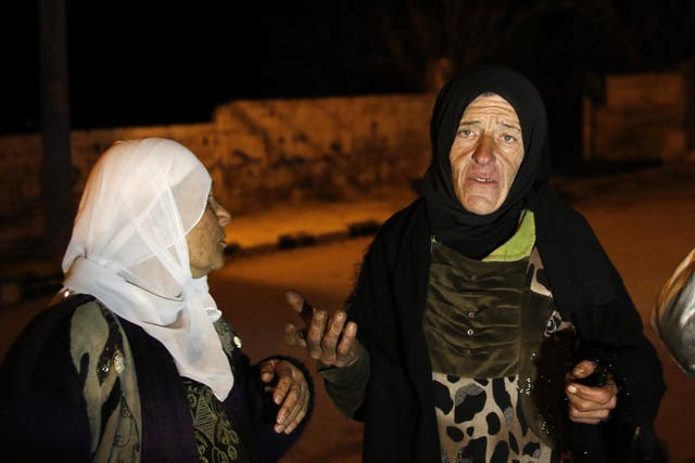 Residents talk to reporters in the besieged town of Madaya, northwest of Damascus, Syria