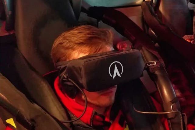 A man wears a virtual reality headset as he rides Galactica