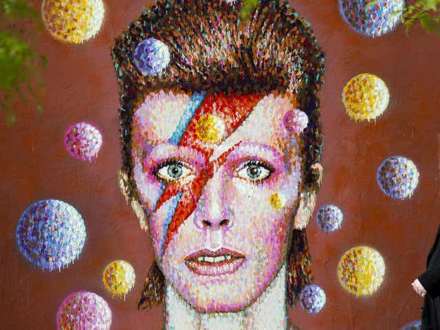 <p>The cover of Bowie's Aladdin Sane album, replicated here in a mural, is one of the most enduring images of the artist</p>