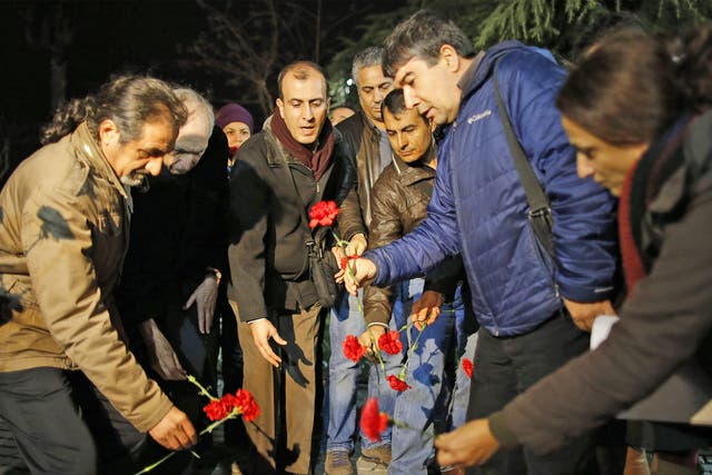 Citizens leave carnations near the site of the blast