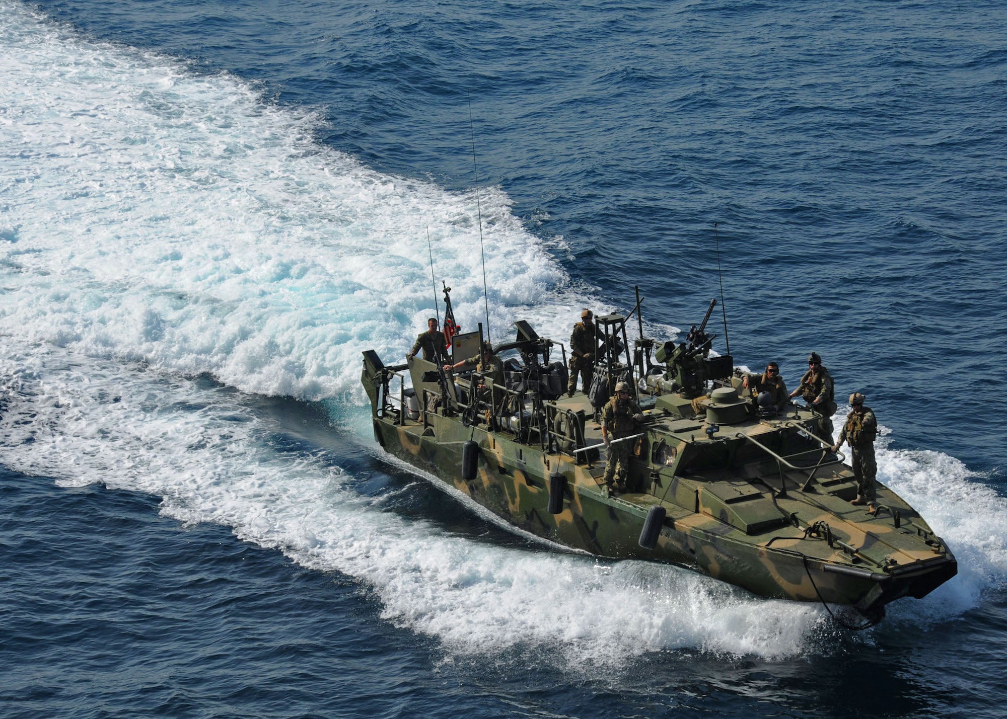 A riverine command boat from Riverine Detachment 23 is shown.
