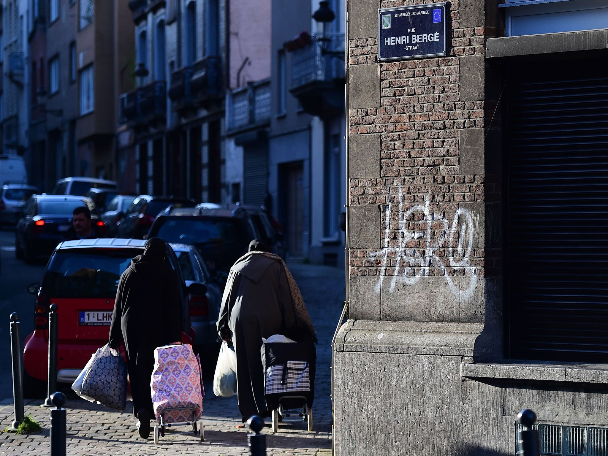 A picture taken on January 8, 2016 in the Brussels district of Schaerbeek shows people walking in the Rue Henri Berge