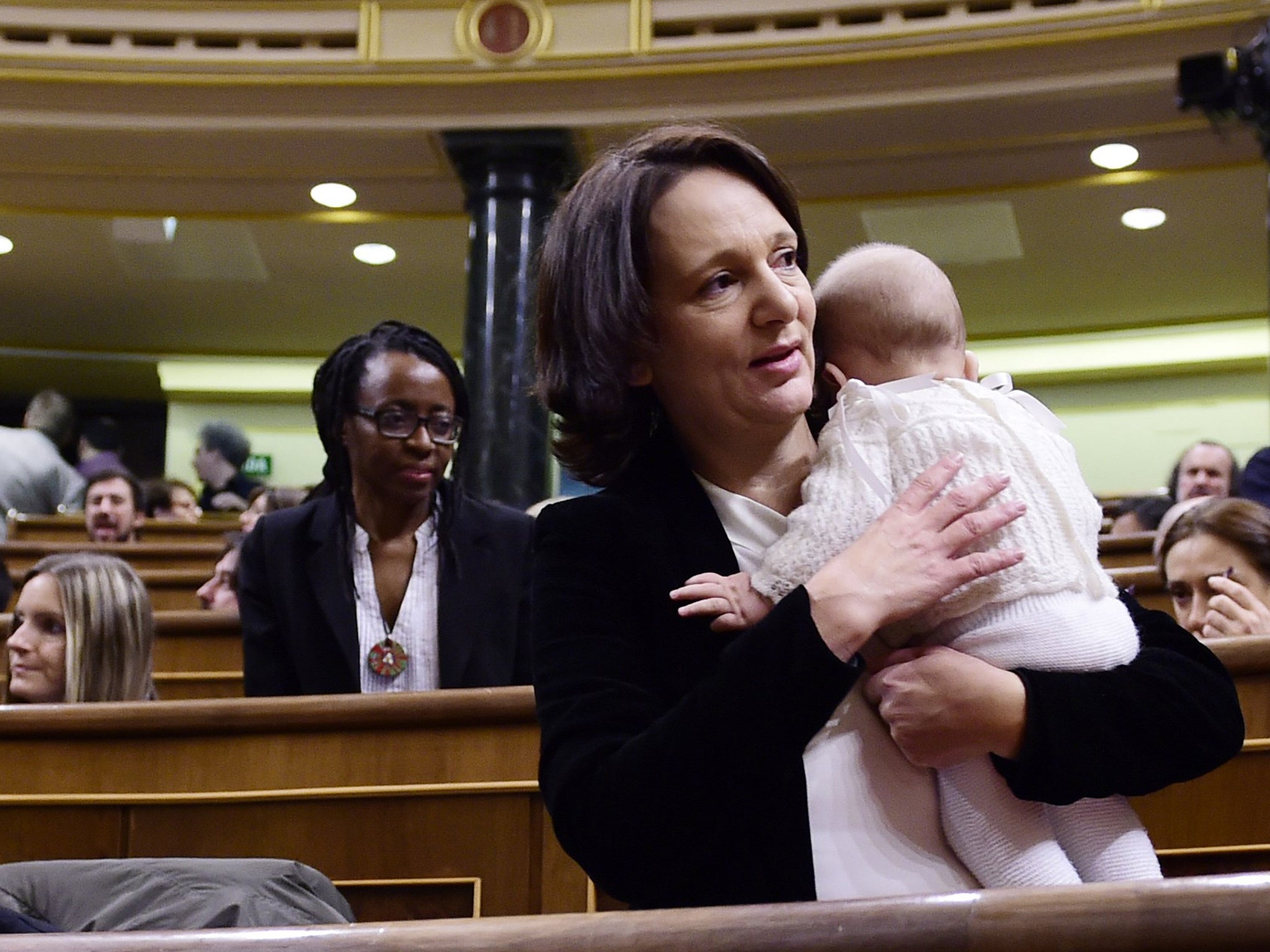 Left wing party Podemos' deputy Carolina Bescansa holds her baby during the constitution of the Congress, at the Palacio de las Cortes in Madrid AFP