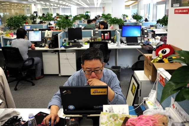 This picture taken on April 16, 2014 shows a man using a laptop at an office of Sina Weibo, widely known as China's version of Twitter, in Beijing