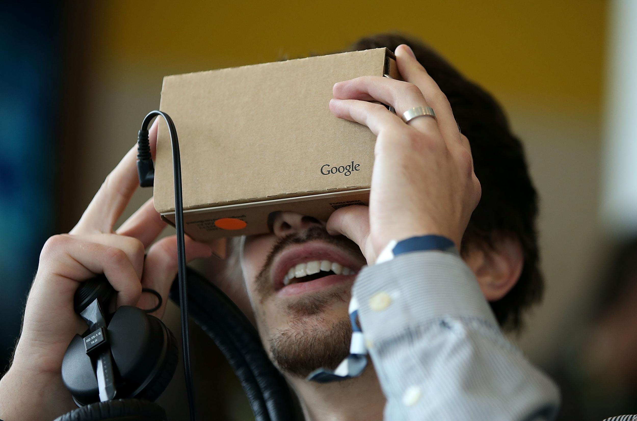 A man tries out the Google Cardboard VR headset at the 2015 Google I/O conference in San Francisco