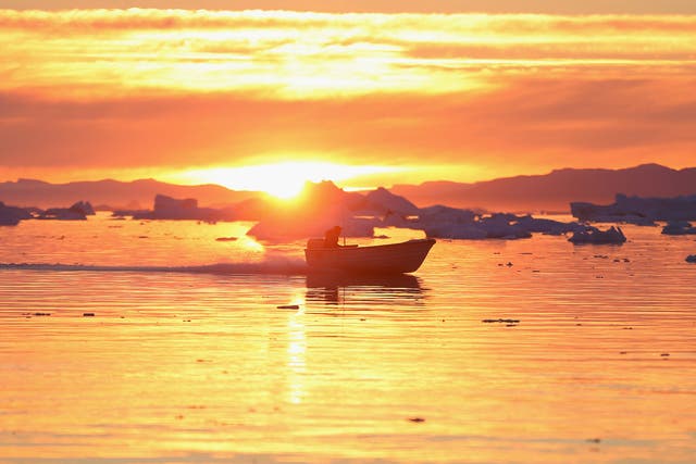 A boat cruises past icebergs that broke off from the Jakobshavn Glacier in Ilulissat, Greenland. The warmer temperatures that have had an effect on the glaciers in Greenland also have altered the ways in which the local populace farm, fish, hunt and even travel across land