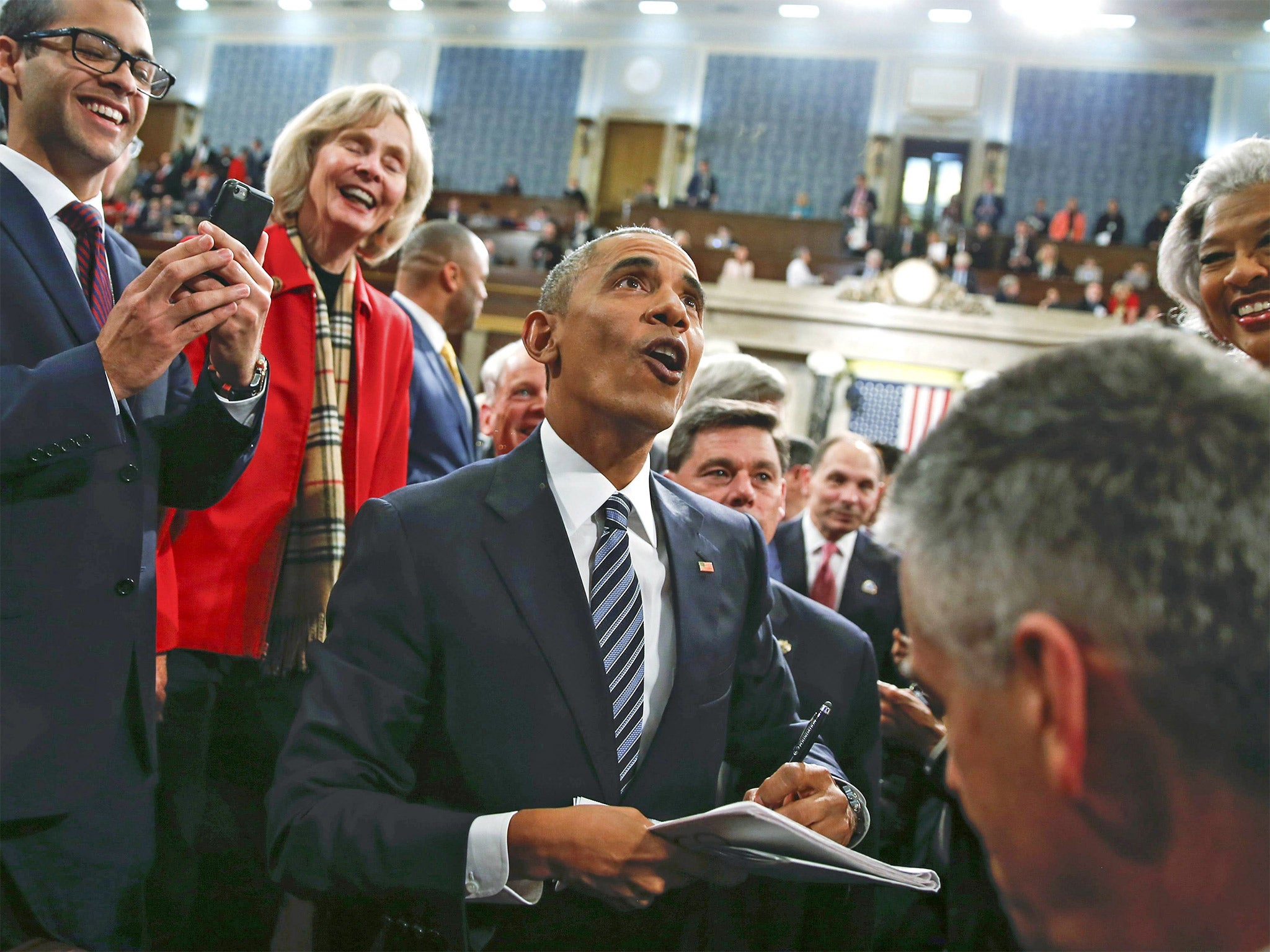 President Barack Obama signs autographs after his State of the Union speech