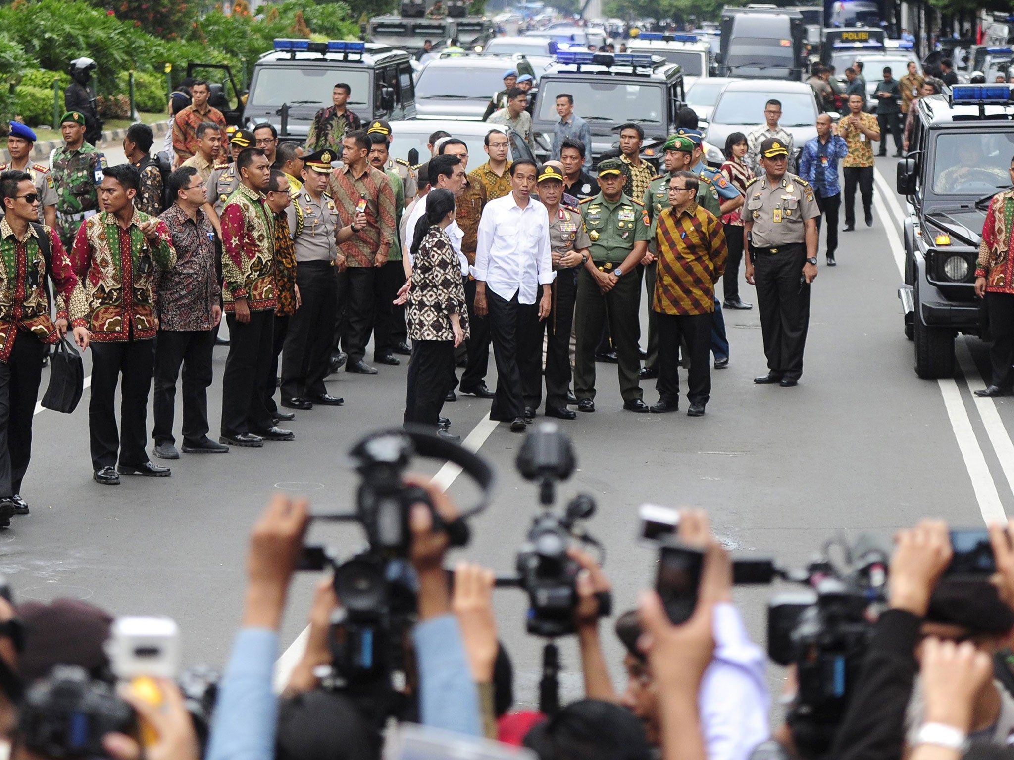 Indonesian president Joko Widodo (C, white shirt) visits the site of a bomb blast at Thamrin business district in Jakarta, January 14, 2016