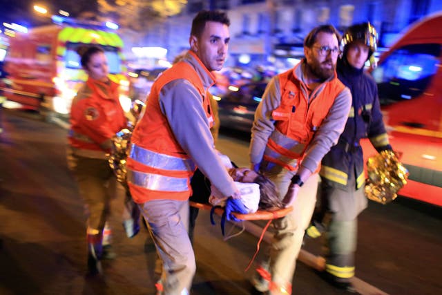 Terror threat: An injured woman is taken from the Bataclan Theatre after the shootings in Paris on 13 November last year