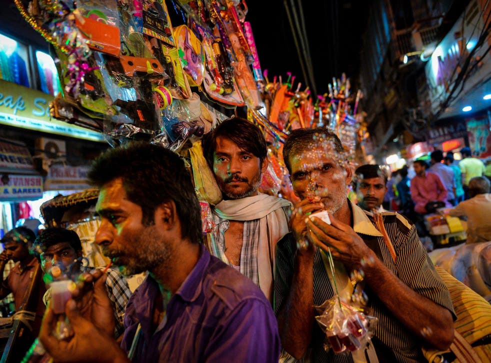 ndian street vendors sell toys during a religious procession passing by the old districts of New Delhi