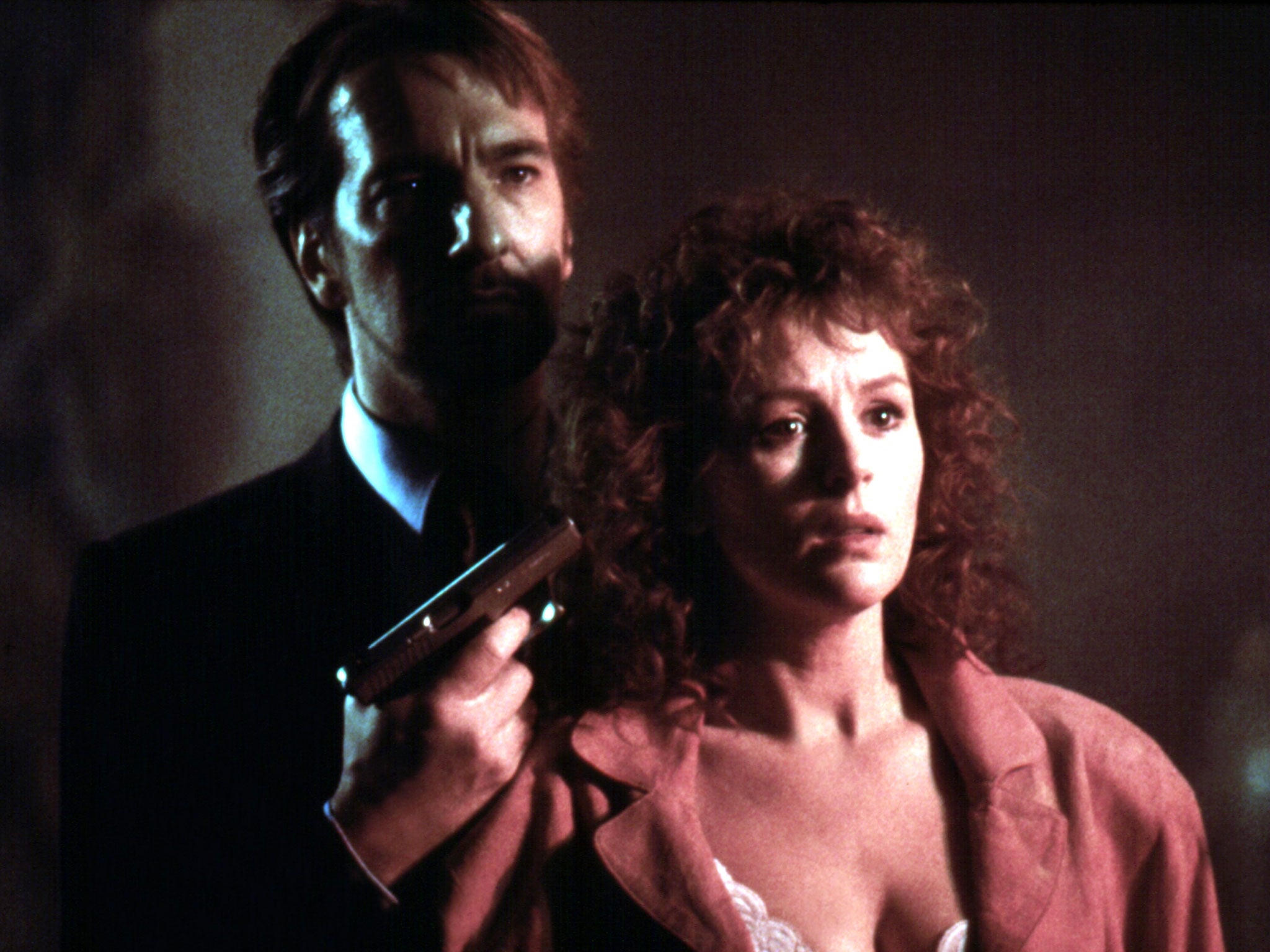 Alan Rickman plays the sneering villain, seen here in a scene with Bonnie Bedelia (Rex)