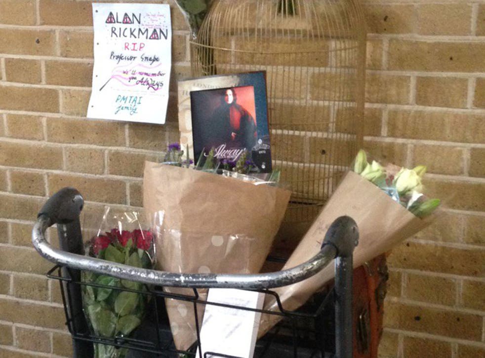 Harry Potter fans laid flowers, photos and other tributes at Platform 9¾