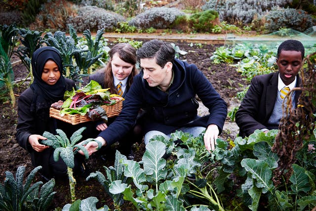 Ben Tish selects vegetables with the pupils at Phoenix High School